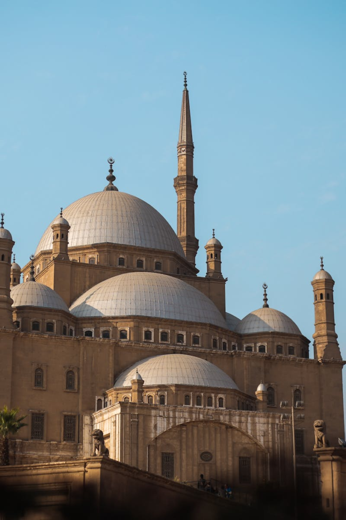 Explore the architectural beauty of the historic mosque in Cairo, featuring majestic domes and minarets.